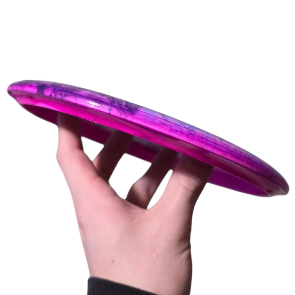 Lavender and magenta dye on Doomsday Discs Despair in Shockwave plastic, side profile