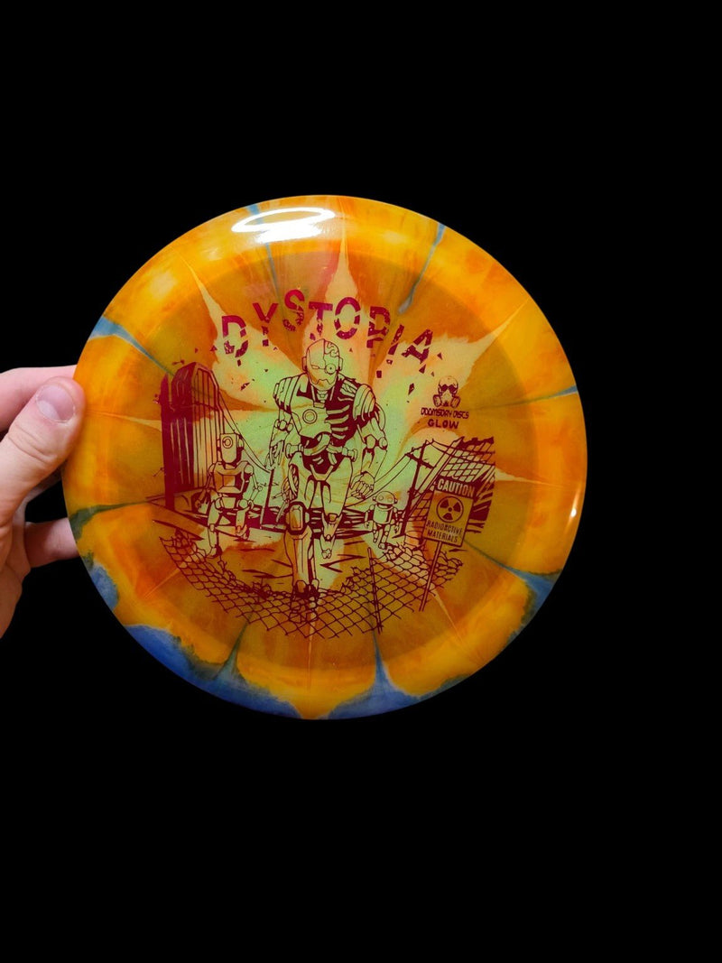 Orange and blue dye on yellow Doomsday Discs Dystopia in Glow Isolation plastic, overhead view