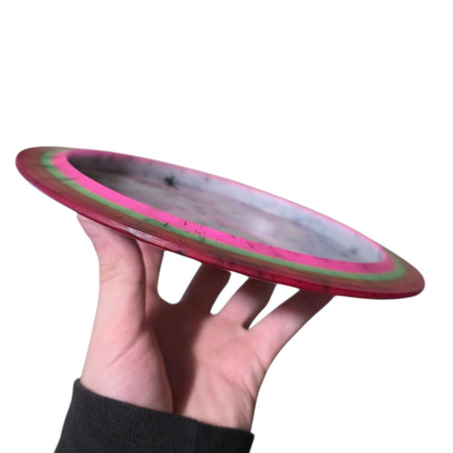 Pink and olive dye on Doomsday Discs Plague in Radioactive Waste plastic, side profile