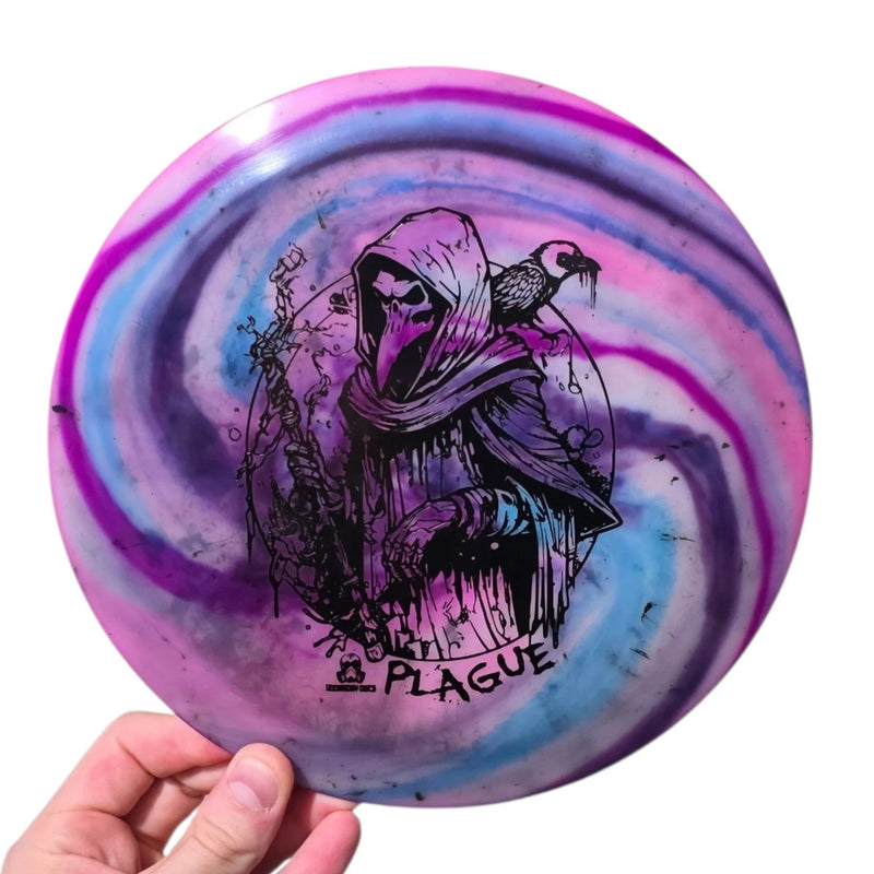 Purple and pink dye on Doomsday Discs Plague in Radioactive Waste plastic, overhead view