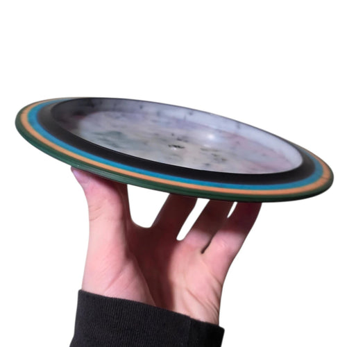 Red and cyan dye on Doomsday Discs Plague in Radioactive Waste plastic, side profile